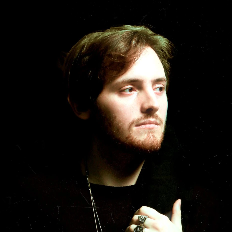 Portrait photo of Alessandro Delfino, graphic designer, founder, on a dark background